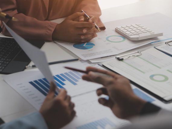 Close up of Business team analyzing income charts and graphs with modern laptop computer. Business analysis and strategy concept.
